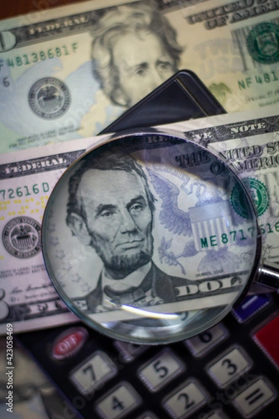 Obraz Five dollar bill with a magnifying glass and calculator