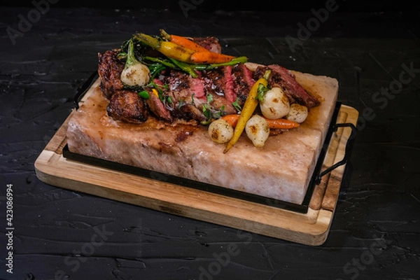 Obraz New York Delmonico grilled 30oz steak with vegetables on marble salt tray