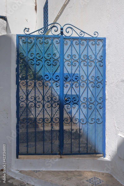 Fototapeta blue door with bars in the Andalusian style