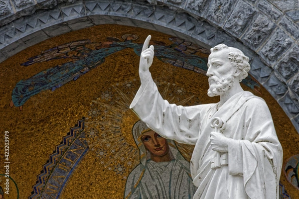 Fototapeta Statue of Saint Peter in Lourdes, in front of the basilica. close up view of the bust in front of a decorated alcove in the sacred square