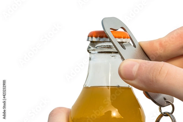 Fototapeta Man with hand using bottle opener opens glass bottle with drink on white isolated background
