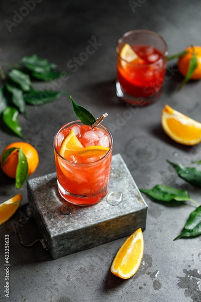Obraz A glass of orange cocktail with ice cubes. Summer refreshing cocktail
