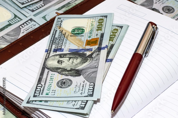 Fototapeta Notepad with pen and dollars