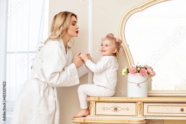 Obraz Happy beautiful family mother and daughter at the mirror in the bedroom together