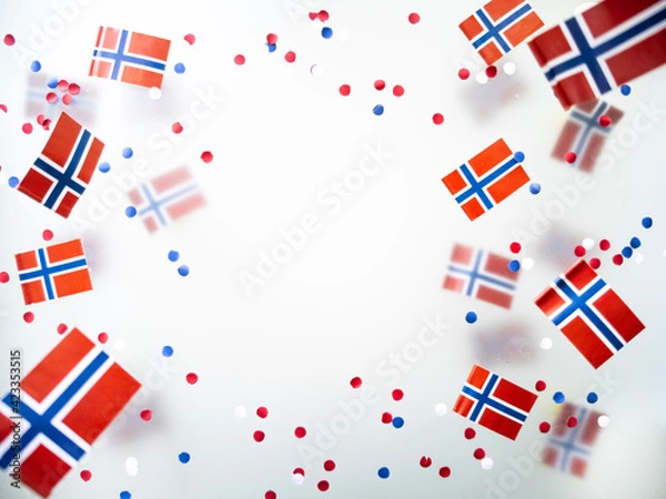 Fototapeta Norwegian independence day, Constitution day, may 17. holiday of freedom, victory and memory. concept of patriotism and faith. paper confetti and mini flags on white foggy background