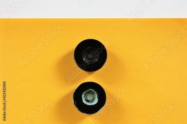 Obraz two caps on the yellow background