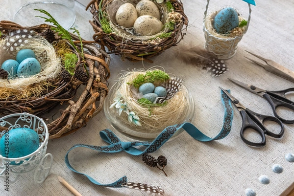 Fototapeta Pastel three colored easter eggs in the nest with cuckooflower in the background isolated on white
