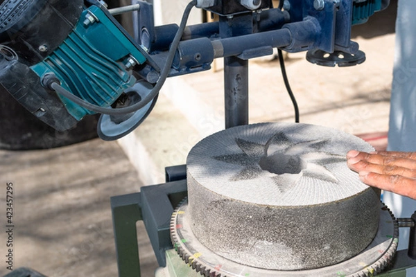 Fototapeta stones used to grind corn being rectified with a special machine for this