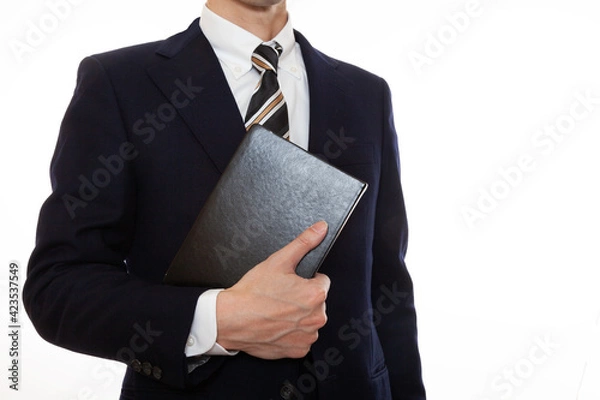 Fototapeta 手に本を持ったビジネスパーソン