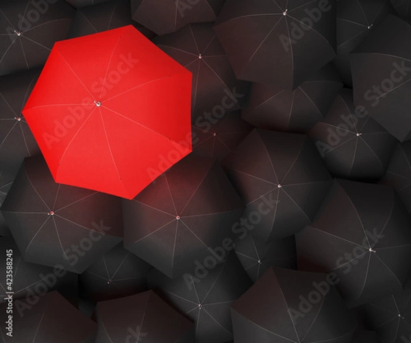 Fototapeta Concept image with lots of black umbrellas and a red umbrella that stands out, be unique
