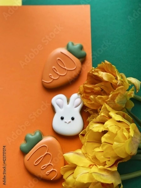 Obraz Cute white Easter bunny cookie with orange tulips 