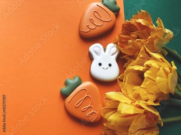 Obraz Cute white Easter bunny cookie with orange tulips 