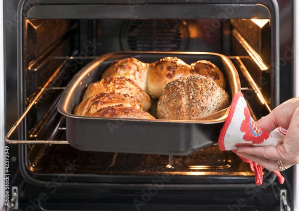 Obraz Baker's hand with bread in oven
