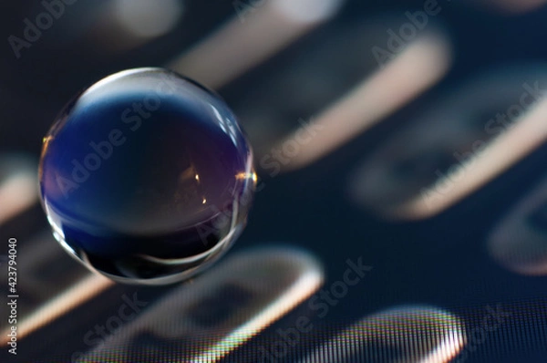 Obraz Glass ball close up view in the computer screen image background
