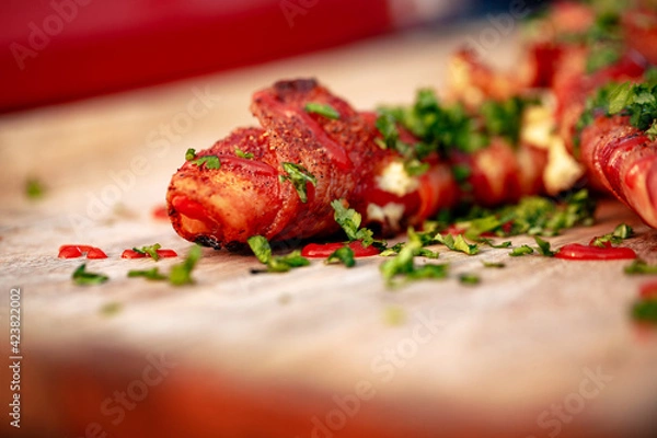 Fototapeta Sweet red pepper stuffed with cream cheese, wrapped in bacon and grilled