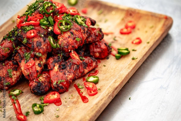 Fototapeta Chicken wing platter with sriracha sauce and fresh chillis