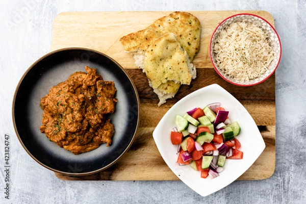 Fototapeta Chicken Makhani with rice, bread and onion salad