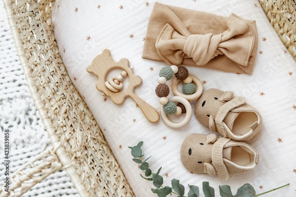 Obraz Top view newborn basket with baby items, booties and toys. Still life background. baby shower or pregnancy announcement.