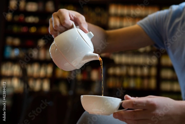 Obraz Man pouring tea into white cup