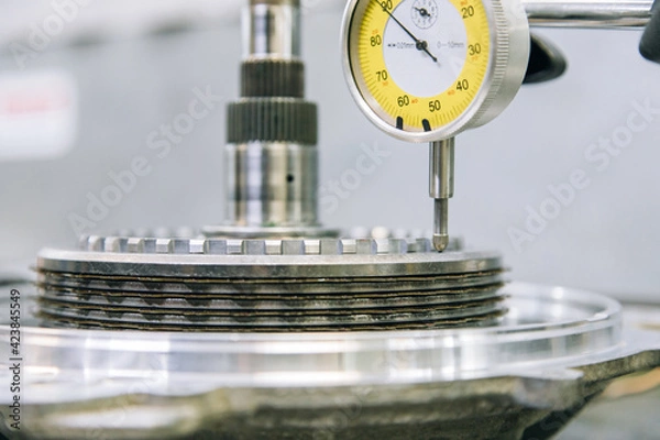Fototapeta Set of various engine and gearbox spare parts. Shiny gears for planetary gearbox.Metal autotechnology background. wheel engine gears, close up. Automatic transmission in section	