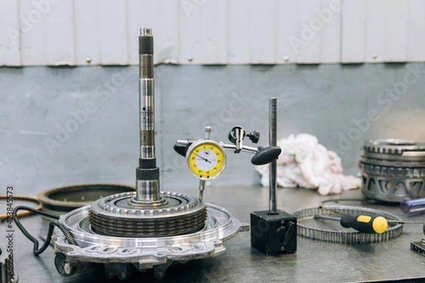 Fototapeta Set of various engine and gearbox spare parts. Shiny gears for planetary gearbox.Metal autotechnology background. wheel engine gears, close up. Automatic transmission in section	