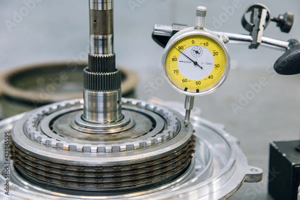 Fototapeta Set of various engine and gearbox spare parts. Shiny gears for planetary gearbox.Metal autotechnology background. wheel engine gears, close up. Automatic transmission in section	