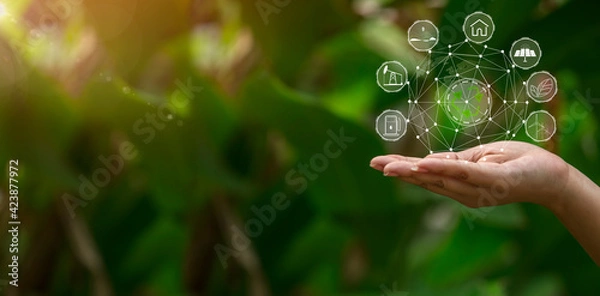 Fototapeta Technology, hand holding with environment Icons over the Network connection on green background.