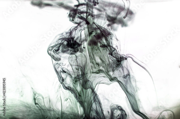 Fototapeta Ink swirls underwater. Ink cloud isolated on black background. Abstract effect of explosion of cosmos universe smoke with particles.