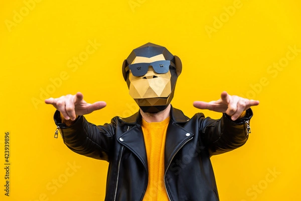 Fototapeta Man with funny low poly mask on colored background