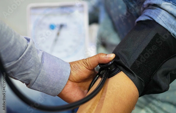 Fototapeta   Indian male doctor check BP or Blood pressure of a patient l