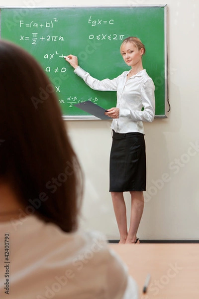 Obraz teacher writes on blackboard