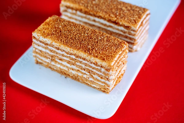 Obraz Honey cake on a red background