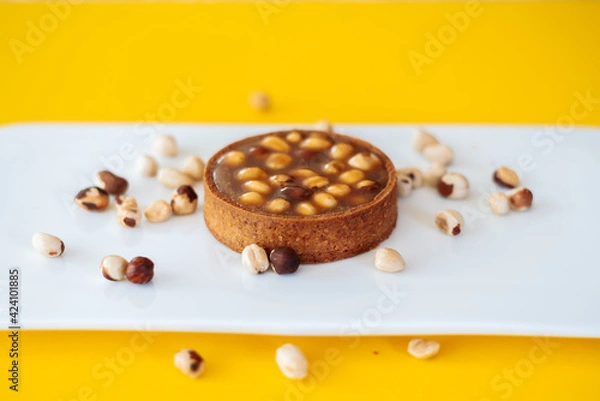 Obraz cake with nuts on yellow background
