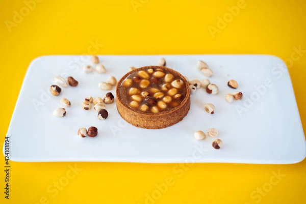Obraz cake with nuts on yellow background
