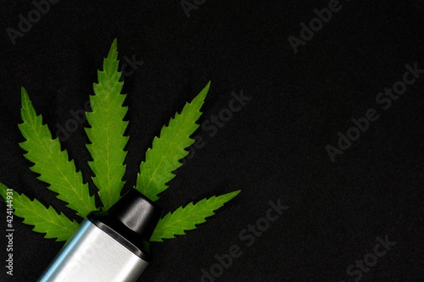 Obraz electronic vaporizer for smoking with cannabis leaf on black background