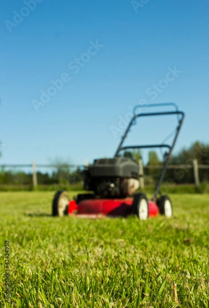 Fototapeta Lawn mower on grass
