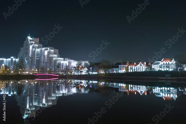 Obraz Evening city in lights, reflected in the water