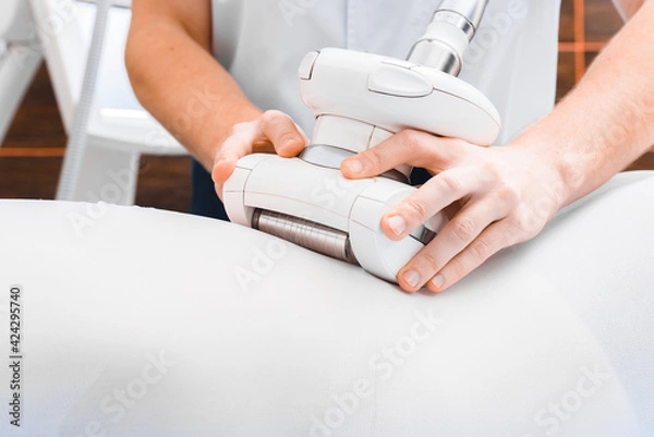 Fototapeta Vacuum roller massage close up. Anti-cellulite lpg massage.