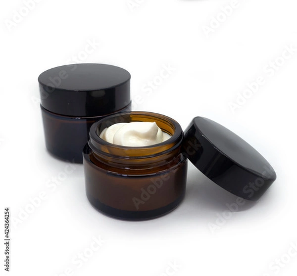 Obraz Mock up template with glass dark jar for cream and cosmetics. Container with lid isolated on white background. Element for advertising cosmetic and pharmaceutical products for health and beauty