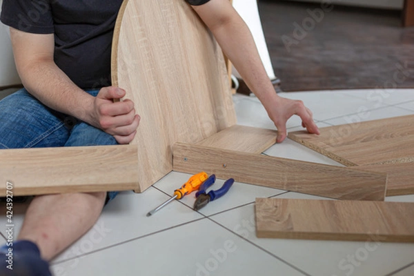 Fototapeta Assembling of furniture with his own hands at home