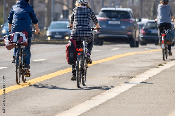 Obraz Leipzig, Saxony, Germany; 03.31.2021 Cyclists on a pop-up cycle path that was newly set up due to the corona pandemic
