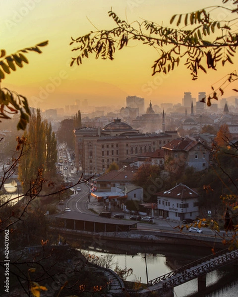 Fototapeta Beautiful view of the city of Sarajevo. View of the City Hall of Sarajevo and the silhouettes of other sights of the city of Sarajevo. Colorful sky at sunset.