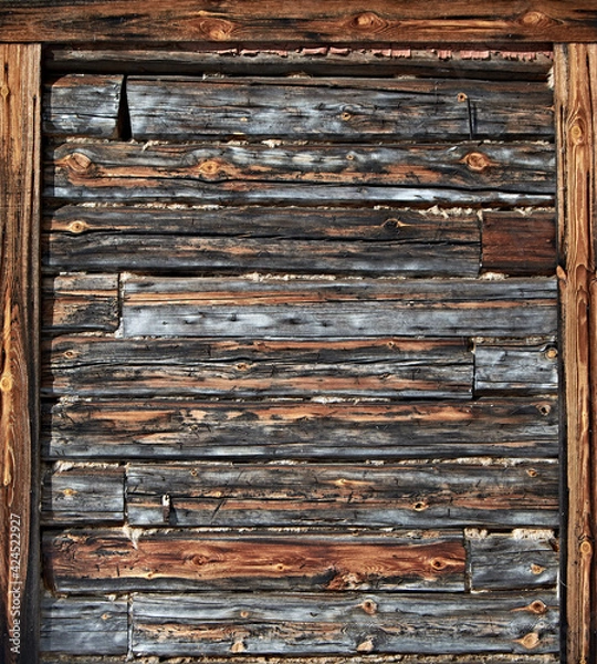Fototapeta The surface of an old wooden wall with a frame on the edges. Natural vintage wood background. Vertical orientation.