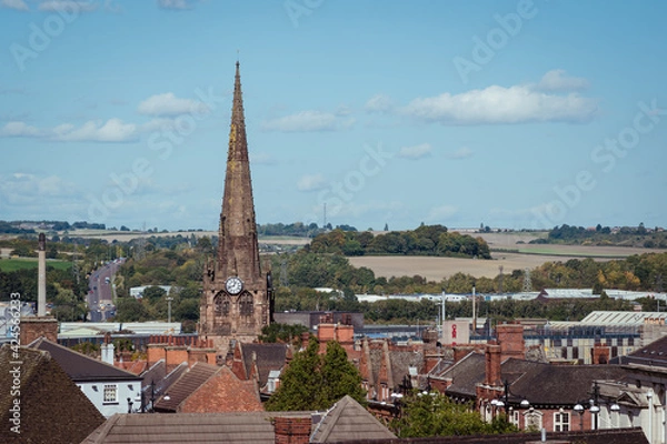 Fototapeta An elevated landscape view over the town centre of Rotherham, showing the rooftops with steeple and spire of the gothic Minster All Saints church