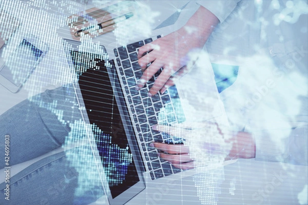 Fototapeta Double exposure of woman hands working on computer and financial theme hologram drawing. Top View. Business concept.