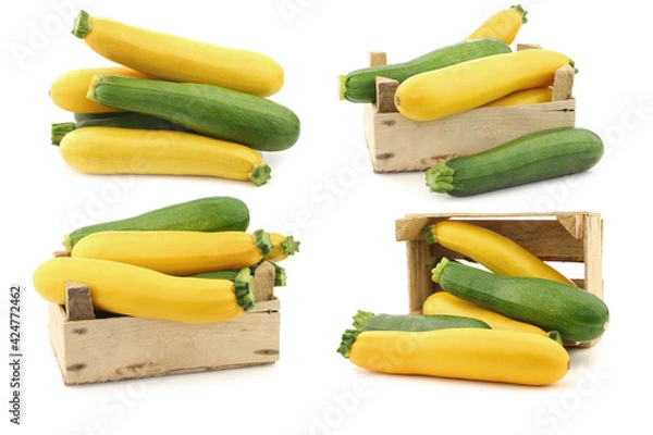 Fototapeta mixed yellow and green zucchini's in a wooden crate on a white background