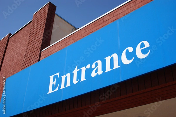 Fototapeta Entrance sign on brick building