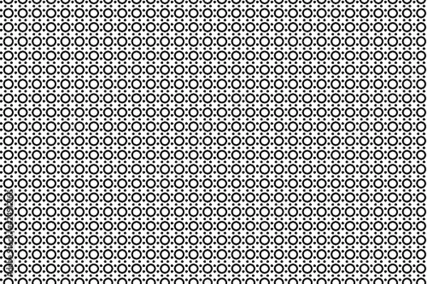 Fototapeta Anillos negro en varios tamaños ordenados verticalmente sobre fondo blanco