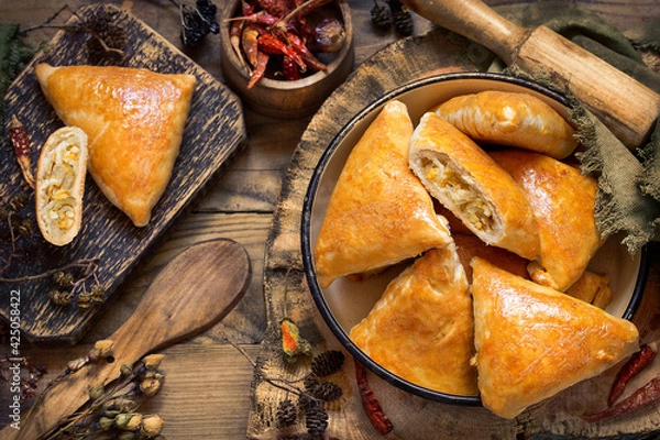 Fototapeta pies with cabbage and shortbread egg on wooden boards in a rustic style