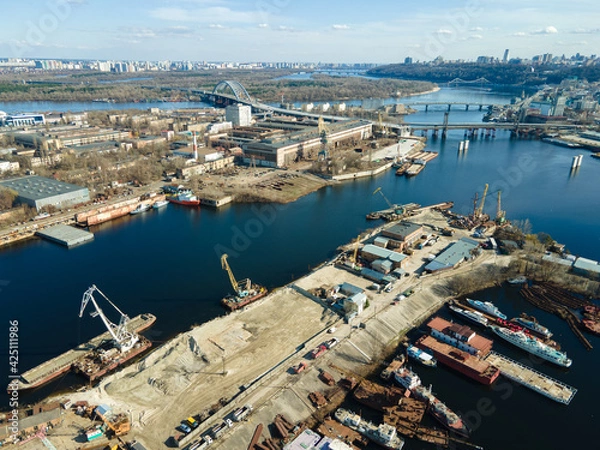 Fototapeta Aerial view of moored old barges and ships in river port